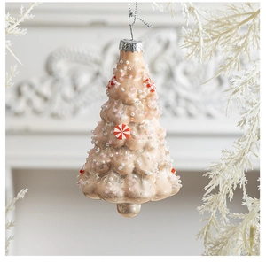 Detail of Christmas tree shaped champagne glass ornament with peppermint patterns and beads