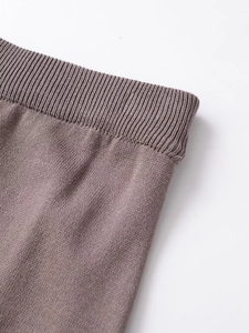 Close-up of dark brown stretch knit waistband showing detailed fabric texture and quality