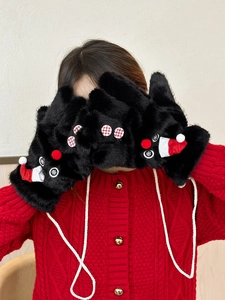 Detail of plush black Christmas snowman mittens with red hat accents and neck cord