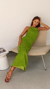 Detail of green backless bodycon dress featuring textured ripples and slim fit design