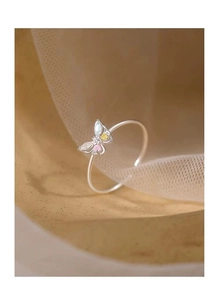 Macro shot of silver butterfly ring featuring pink yellow and white colorful gemstones