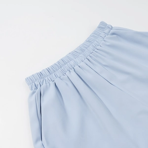 Detail of light blue elastic waistband showing high-quality stitching and fabric texture