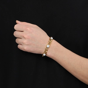Detailed close-up of gold plated Cuban chain bracelet featuring white turquoise stone inlays