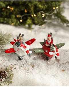 Detailed close-up of iron Santa Claus and reindeer flying mini planes on artificial snow