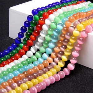 Macro shot of colorful round cat eye stone beads arranged on a white display stand