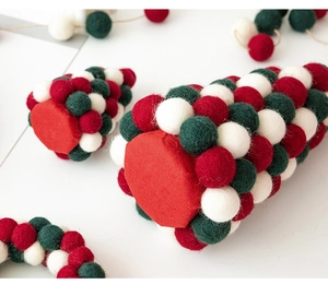 Macro shot of red, white, and green wool felt ball Christmas tree with soft texture