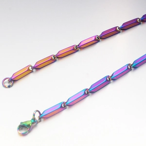 Close-up of rainbow titanium steel cuban link chain with colorful gradient plating finish
