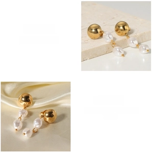 Detailed macro view of gold ball stud earrings featuring elegant white pearl pendants