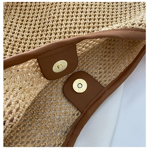 Detail of a strong magnetic buckle on a woven beach bag with premium leather trim finish