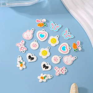 10pcs colorful painted alloy animal charms with rabbit and flower patterns on blue background