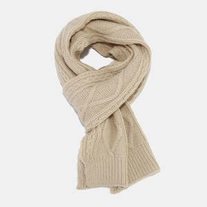 Beige cable knit winter scarf for women made of thick warm material shown in flat lay view