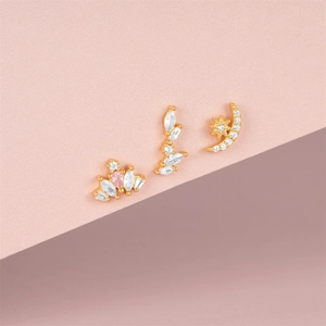 Detailed view of S925 silver moon star and pink gem stud earrings on pink background