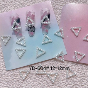 Macro detail of white triangle resin pearl nail art accessory with YD-604 model mark