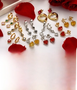 Macro view of titanium steel heart earrings set with colorful cubic zirconia stones