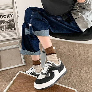 Close-up of color-block crew socks with letter patch and retro platform sneakers