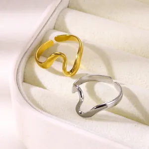 Detail of adjustable wavy gold and silver rings presented in a luxury jewelry box