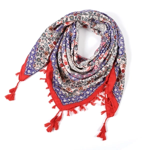 Macro shot of bohemian jacquard square scarf featuring floral patterns and red tassels
