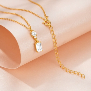 Detail of gold S925 silver necklace featuring a rectangular zircon pendant and adjustable chain