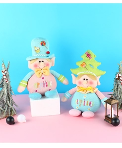 Detail of knit Christmas elf dolls with festive Merry Christmas embroidery and hats