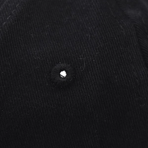 Close-up of the black cotton twill fabric with a reinforced embroidered ventilation eyelet