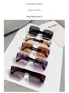 Macro shot of stylish oversized sunglasses with gradient lenses and hollowed metal logo details