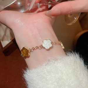 Détail macro d'un bracelet fleuri vintage français avec pétales en résine blanc et ambre