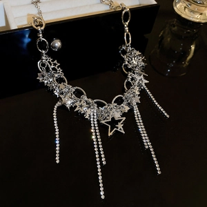 Detail view of silver star necklace with sparkling rhinestone tassels and metal chains