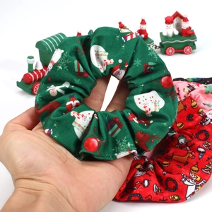 Detailed view of green and red Christmas scrunchies with Santa and snowman patterns