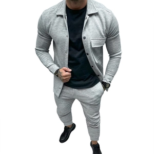 Close-up detail of grey twill texture on men's casual jacket and matching jogger suit