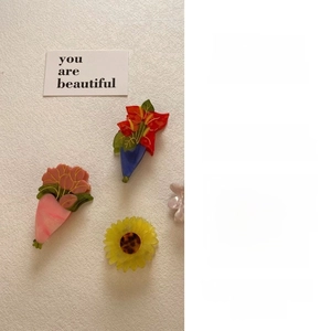Detailed view of elegant acetate hair clips with sunflower and floral design concept