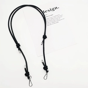 Adjustable black braided bag strap with silver lobster clasps on a minimalist background