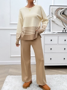 Detail of beige and camel knit set showing striped cuffs and soft textured fabric finish