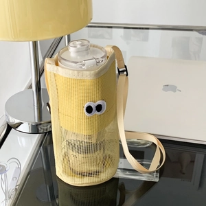 Detail of ginger yellow mesh water bottle bag with cute cartoon eyes and adjustable strap