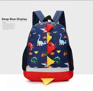 Detail of dark blue dinosaur backpack with 3D scales and silver safety reflective strip