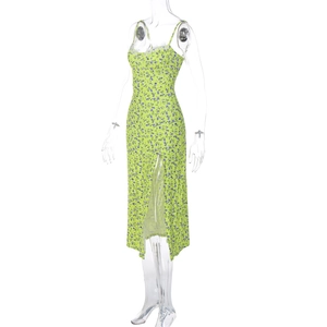 Detail of light green floral midi dress with lace trim and high side slit feature