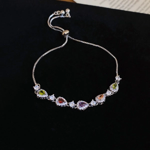Detailed macro view of colorful pear-cut zircon stones with silver adjustable chain