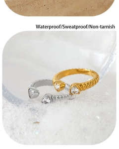 Macro shot of waterproof heart zircon rings with gold and silver spiral textured bands