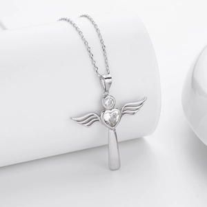 Detailed macro view of S925 sterling silver heart cross pendant with zircon wings