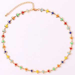 Close-up of golden chain necklace with colorful heart-shaped beads and lobster clasp