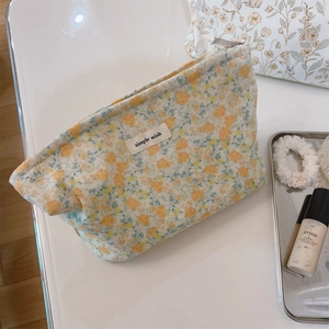 Detailed macro shot of floral cream velvet makeup bag with Simple Wish woven label