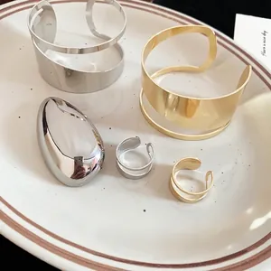 Irregular hollow metal open bracelets and matching double-line rings in gold and silver