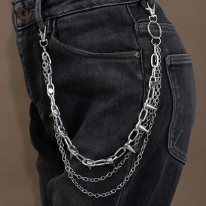 Detail of silver multi-layered punk wallet chain with sharp metal spikes on black jeans