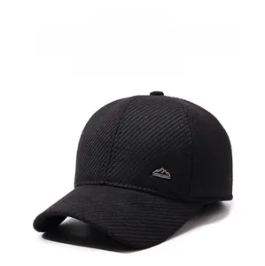 Detail of black winter baseball cap with textured warm fabric and mountain metal logo