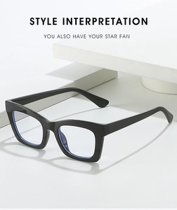 Close-up of black square eyewear frame displayed on white geometric props