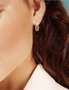 Close-up of minimalist U-shape 18k gold plated stainless steel hoop earrings on model