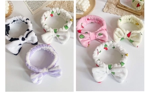 Close-up showing various plush coral fleece headbands with leopard and floral patterns