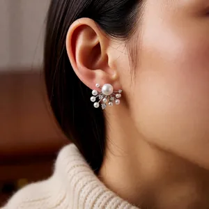 Elegant silver pearl zircon firework earrings on a model wearing a white knit sweater