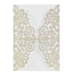 Macro detail of laser-cut gold glitter invitation cover with intricate hollow pattern