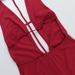 Detail of red deep V-neckline with cross-strap design on a sleek, high-elastic jumpsuit