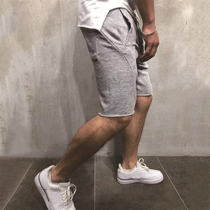 Men's casual grey athletic shorts in a side view pose with a minimalist cotton knit texture